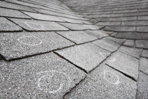 Old roof with hail damage, chalk circles mark the damage. Shallo